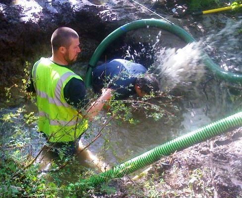 Employees Work With Water Hose