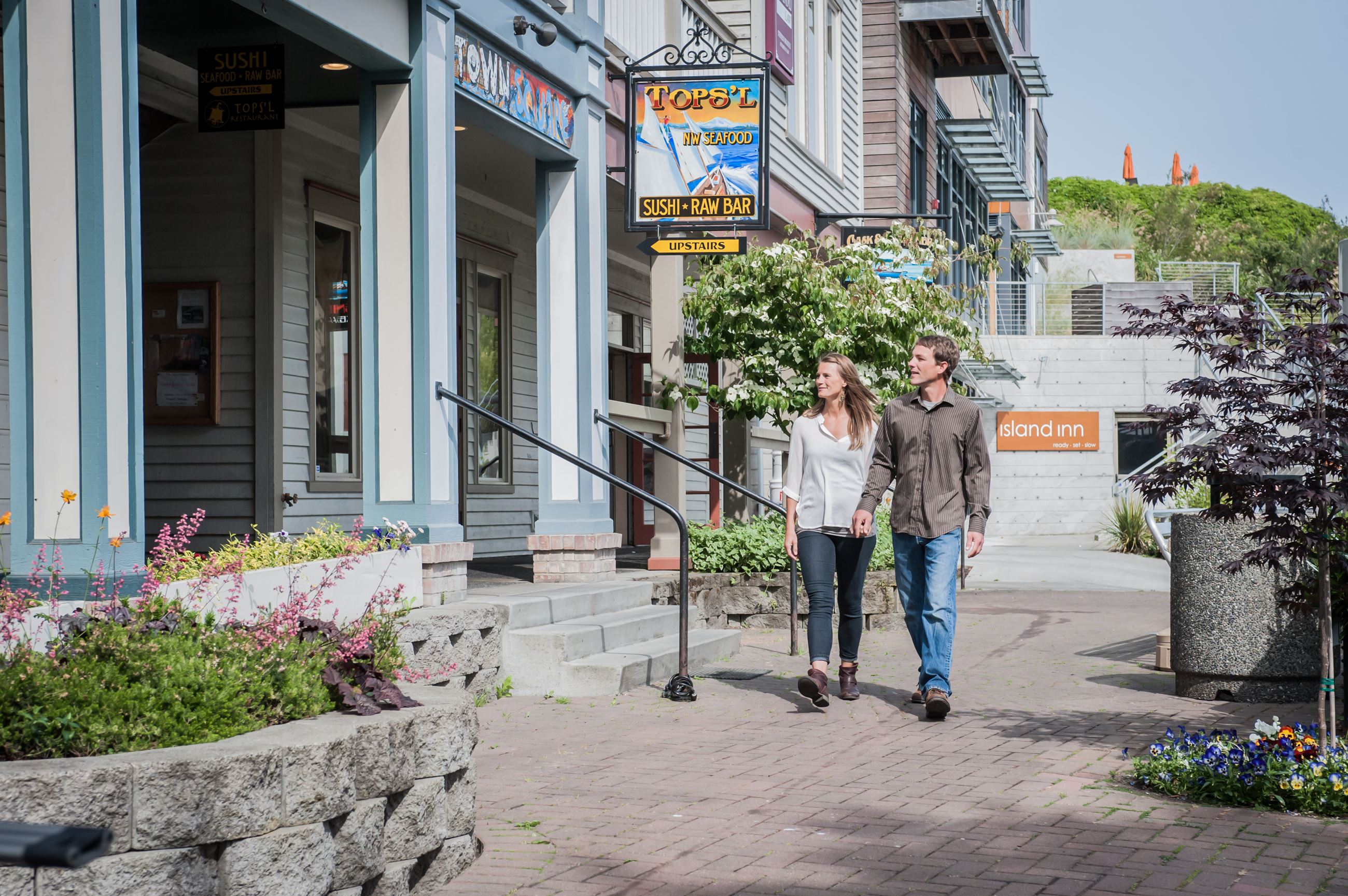Couple Walking By Businesses